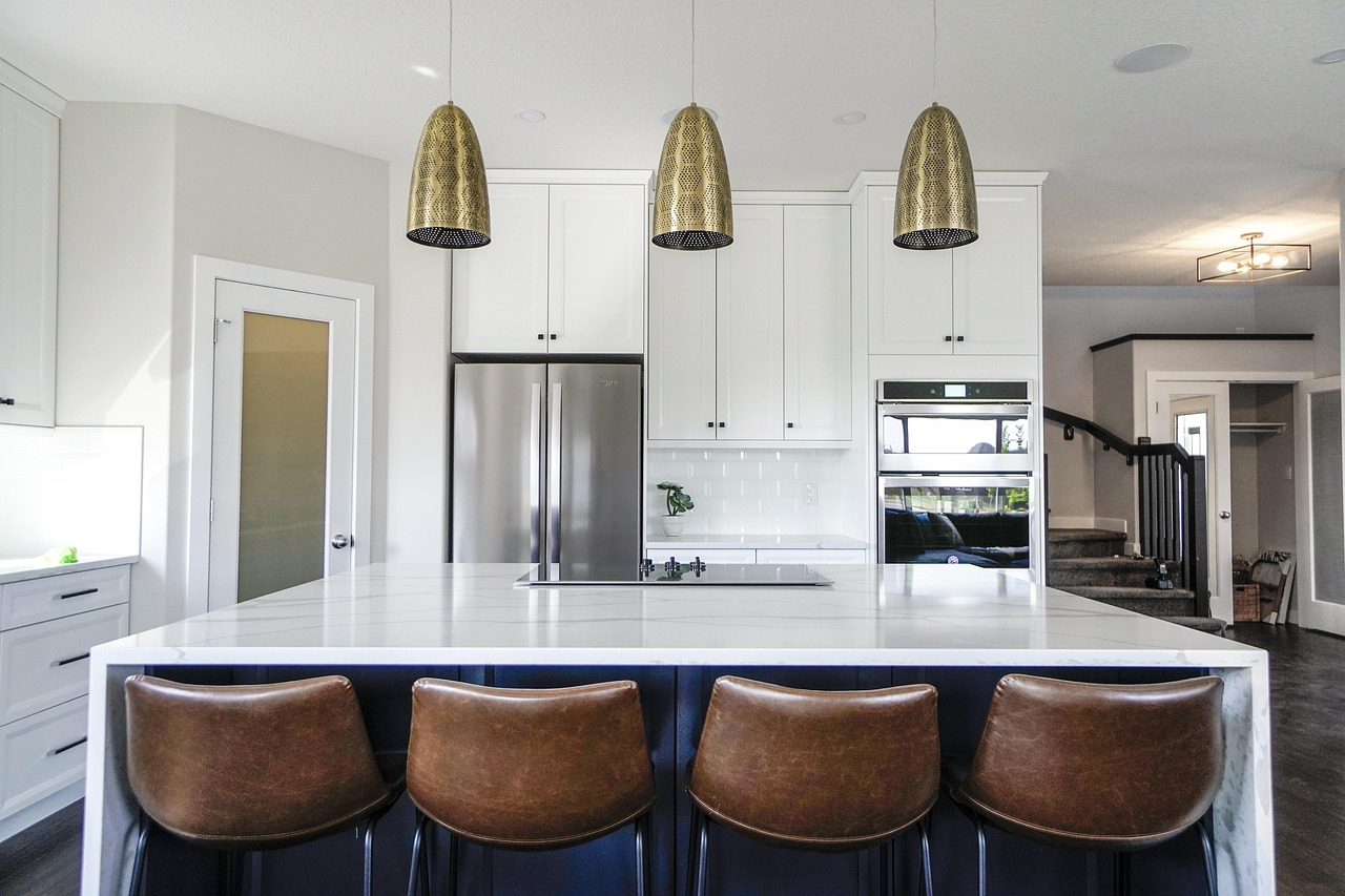 Marble kitchen island with concealed storage and appliance zones